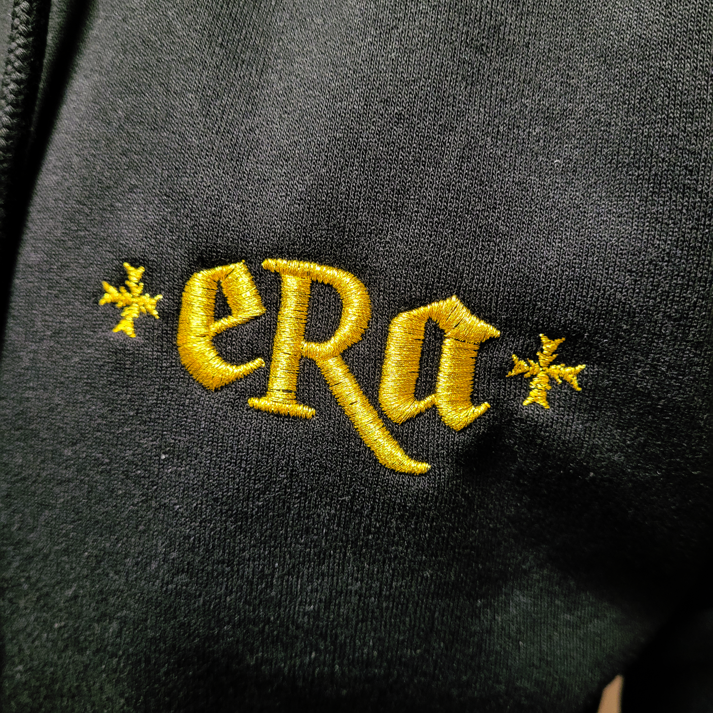 Black unisex hoodie with embroidered "ERA"